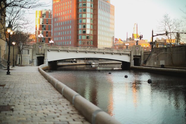 A bridge over a river with a building in the background