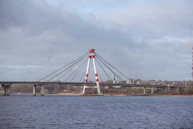 A bridge over the river with a white and red pole that says'bridge '