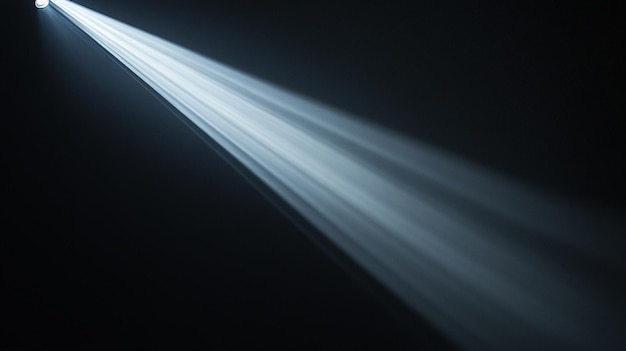 Bright beams of light radiate from a single source in a dark environment at night