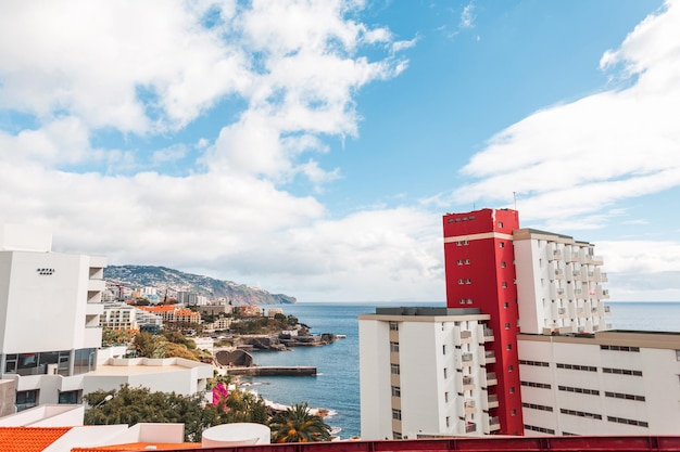 Bright beautiful city of Funchal with houses mountain and ocean on Madeira island on a sunny day