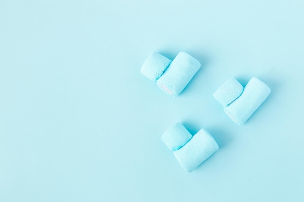 Bright blue marshmallows in the shape of a heart on a blue background