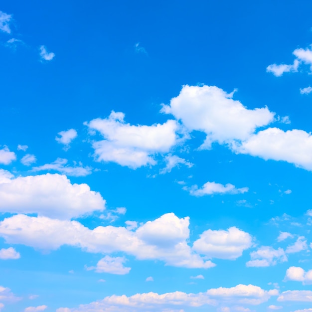 Bright blue sky with white heap clouds, may be used as background. Cloudscape