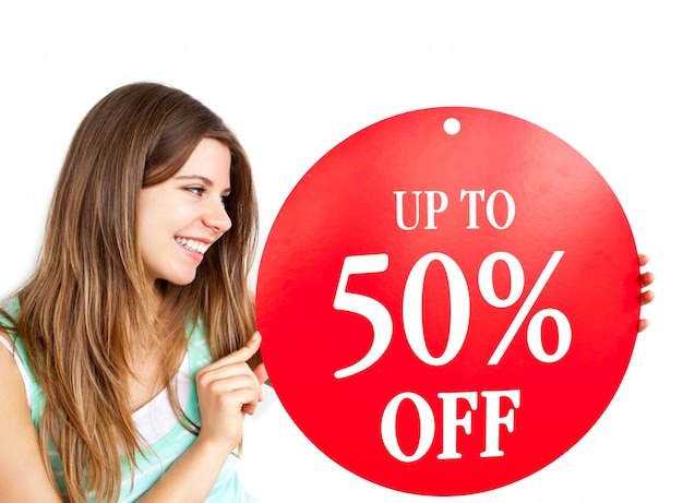 Bright caucasian woman holding a "up to 50% off" red banner