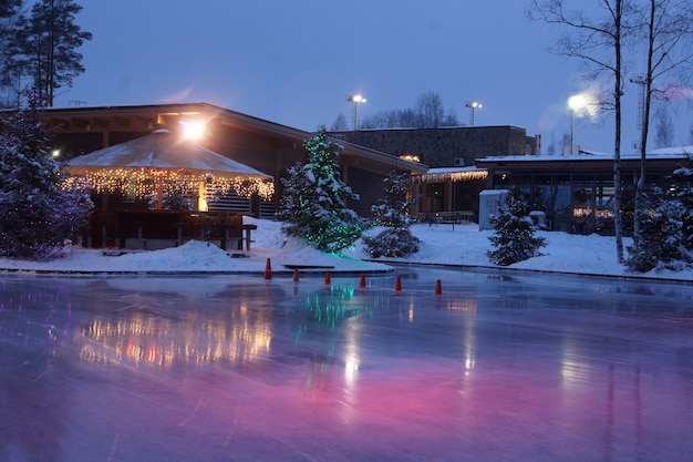 Bright Christmas coffee shop on the street ice rink