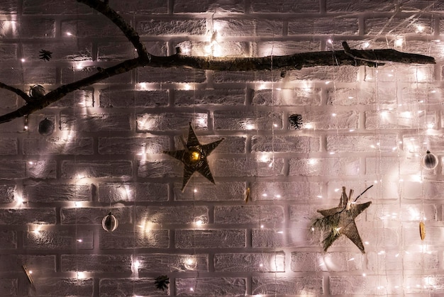 Bright Christmas garland of stars on a brick wall