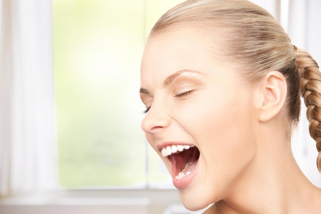 bright closeup picture of unhappy screaming woman