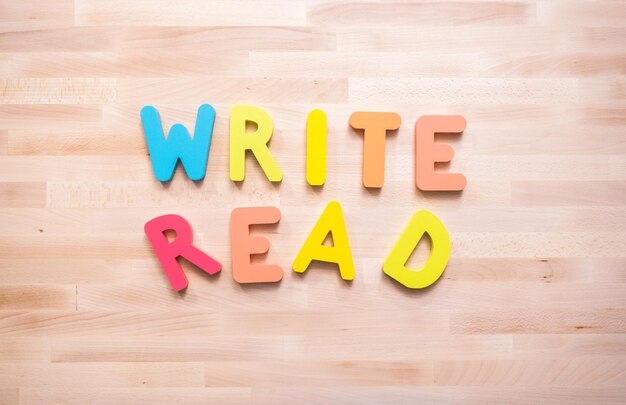 Bright color wooden WRITE and READ signs on wood desk.