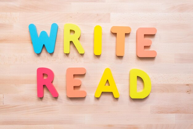 Bright color wooden WRITE and READ signs on wood desk.