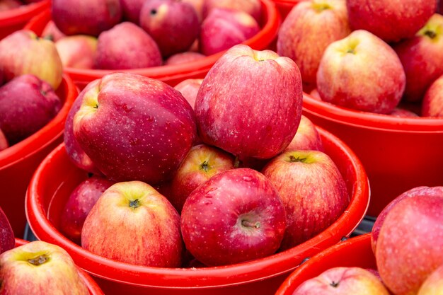 Bright colored apples in buckets