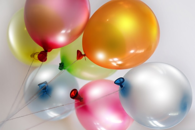 Bright colored balloons on light background