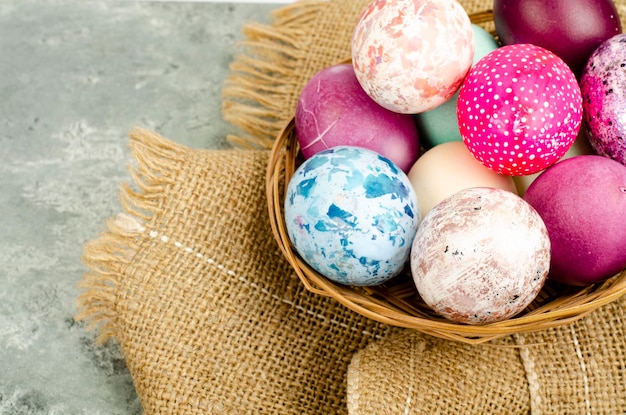 Bright colored Easter eggs on platter, holiday background. Studio Photo