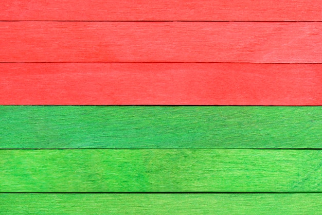 Bright colorful texture of wooden boards painted in green and red Christmas colors