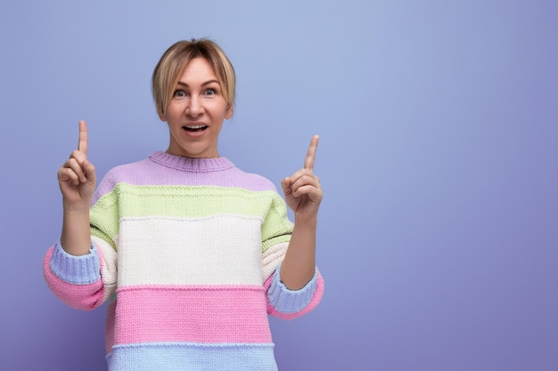 Bright cute blondie woman showing copy space on purple background