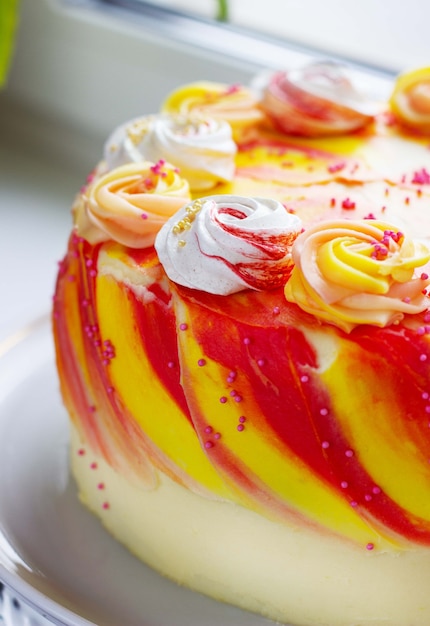 Bright festive cake with roses on the windowsill