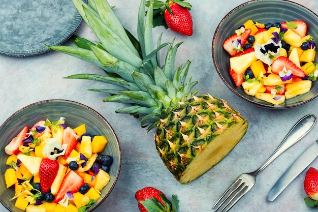 Bright fruit salad with edible flowers