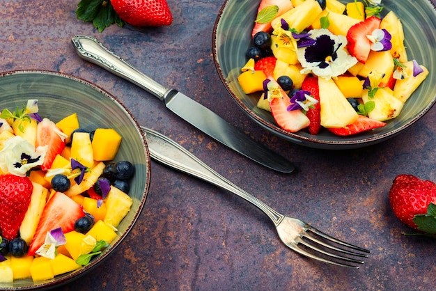 Bright fruit salad with edible flowers