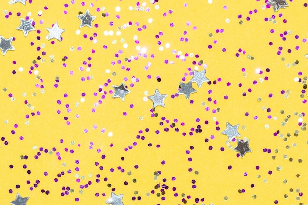 Bright fuchsia pink shiny glitter on a yellow background festive backdrop for your project