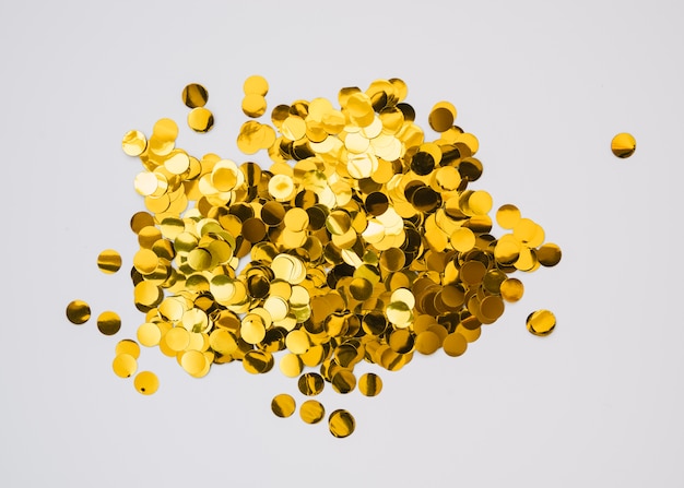 Bright golden confetti on white background