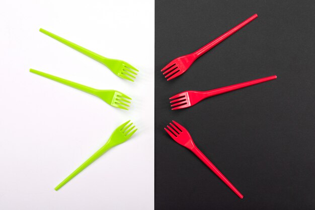 Bright green and red forks on black and white