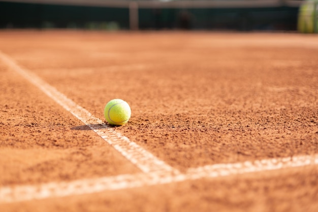 Bright greenish yellow tennis ball on the line