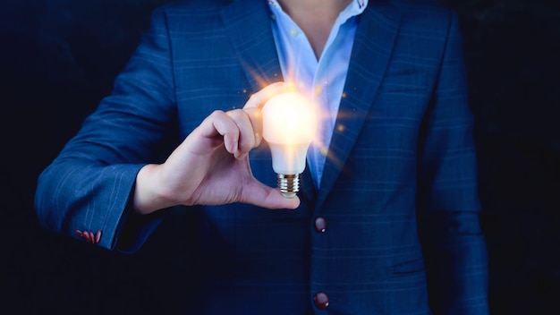 Bright idea in hand Business manHands holding light bulb for concept new idea concept with innovation and inspirationtechnology in science and communication concept