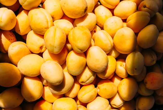 Bright juicy yellow apricots on a farmers market stall