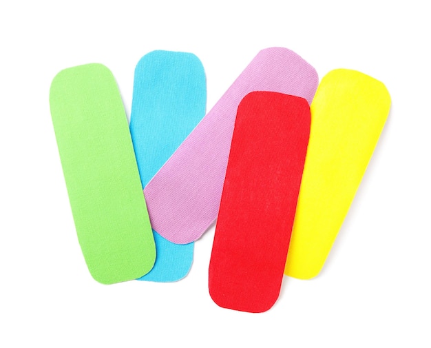 Bright kinesio tape pieces on white background top view