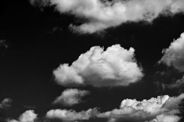 Bright landscape of white puffy cumulus clouds on blue clear sky.