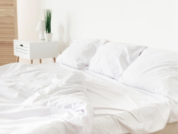 Bright modern bedroom with white sheets