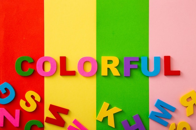 Photo bright multicolored alphabet with colorful wording background flat lay