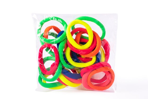 Bright, neon elastic hair 
in transparent packaging on white isolated background.