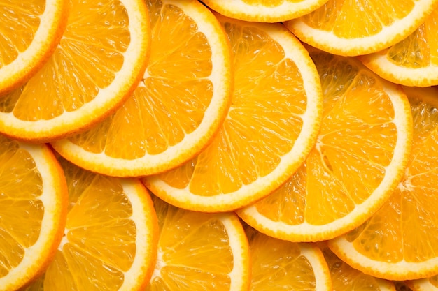 Photo bright orange background from slices of juicy orange