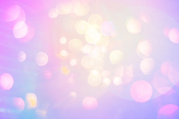 Bright pearly fantasy background. Lens flare bokeh in neon colors on a sunny sky. Funny summer or spring texture