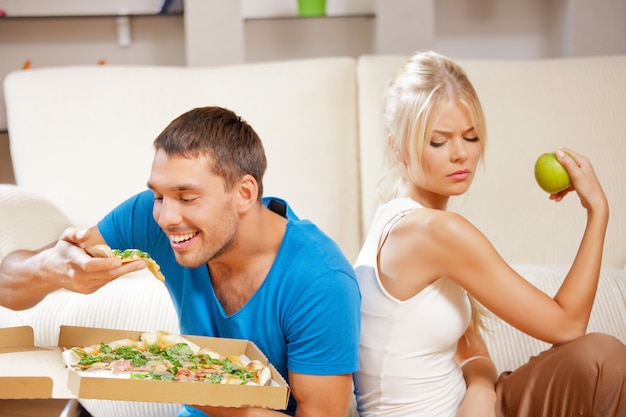 bright picture of couple eating different food (focus on man)