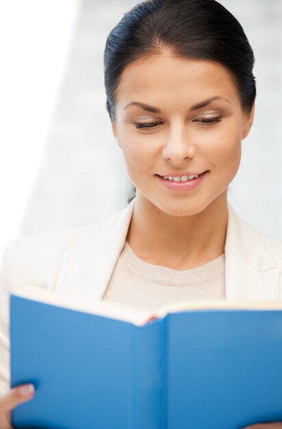 bright picture of happy and smiling woman with book