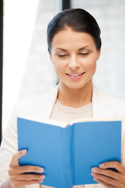 bright picture of happy and smiling woman with book