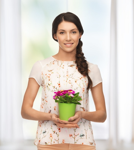 bright picture of lovely housewife with flower in pot