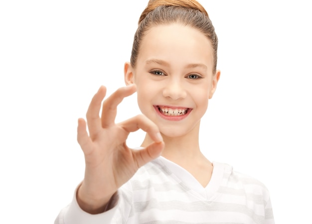 bright picture of lovely teenage girl showing ok sign