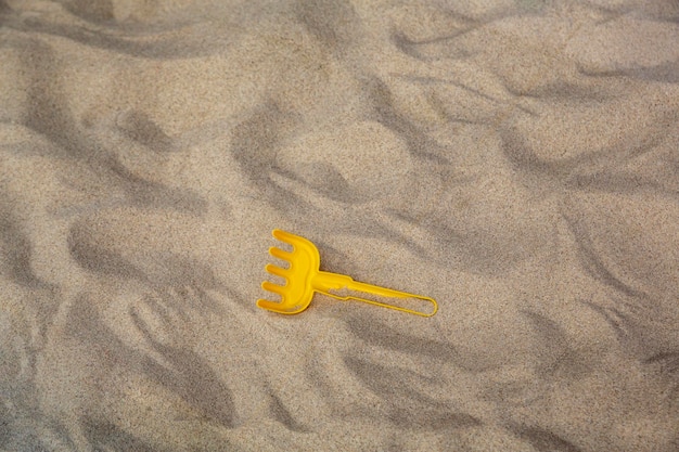 Bright plastic children's toys in the sand