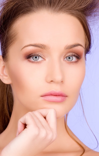 bright Portrait of lovely woman over blue wall