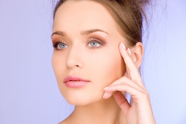 bright Portrait of lovely woman over blue wall