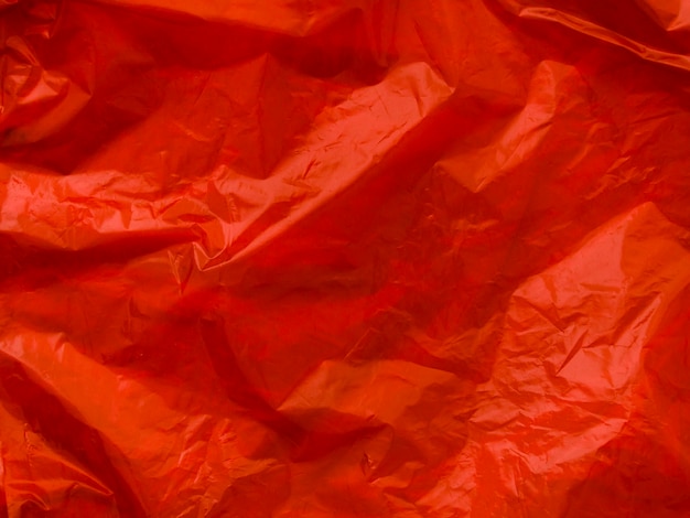 Bright red crumpled plastic bag background