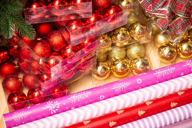 Bright red and golden Christmas bubbles wrapping paper on the table Decorating Christmas tree concept