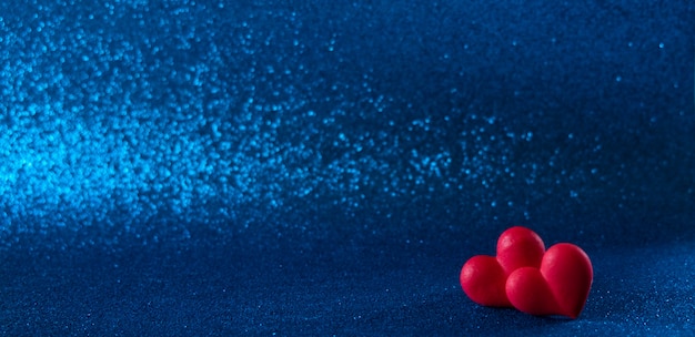 Photo bright red hearts abstract blue  bokeh background
bright red hearts abstract blue bokeh background. valentines day texture.