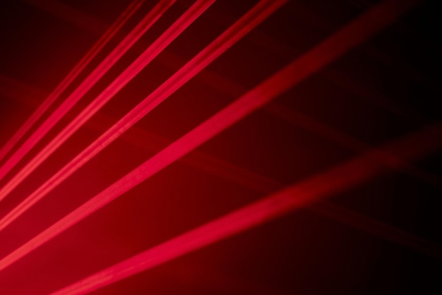 Bright red neon laser lights illuminate the darkness creating lines and triangle shapes in scifi effect