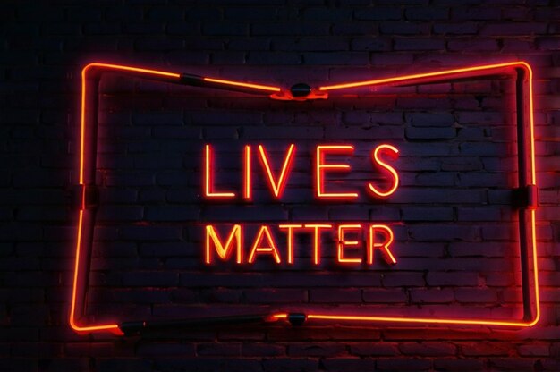 Photo bright red neon sign that says black lives matter on a brick wall background