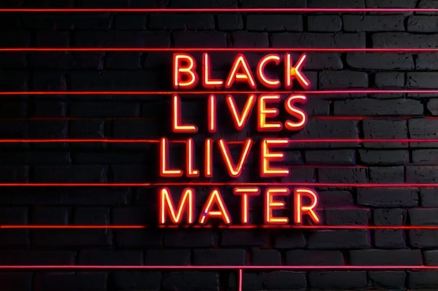 Photo bright red neon sign that says black lives matter on a brick wall background