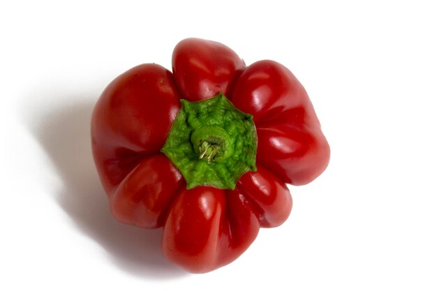 Bright red ribbed paprika pepper isolated on white background top view