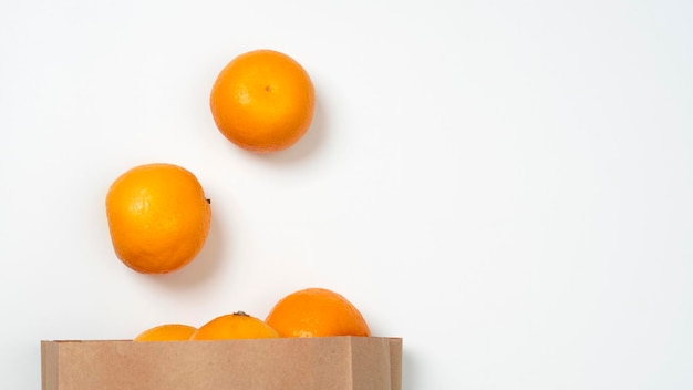 Bright ripe orange oranges in the package on a white background. View from above.