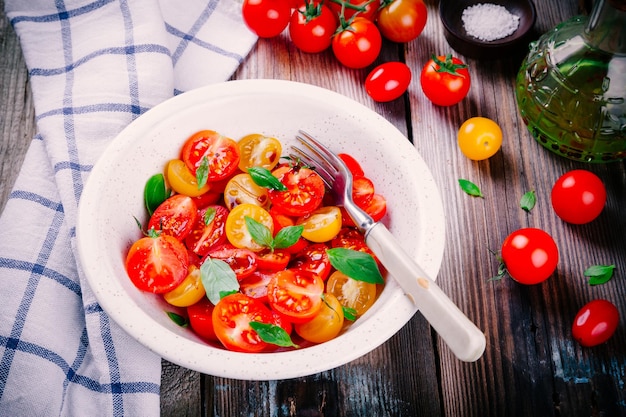 Bright salad of organic cherry tomatoes with basil balsamic and olive oil